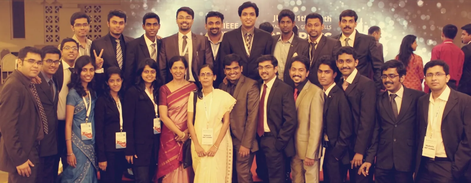 A large group of IEEE student members and faculty in formal dress at an IEEE event.